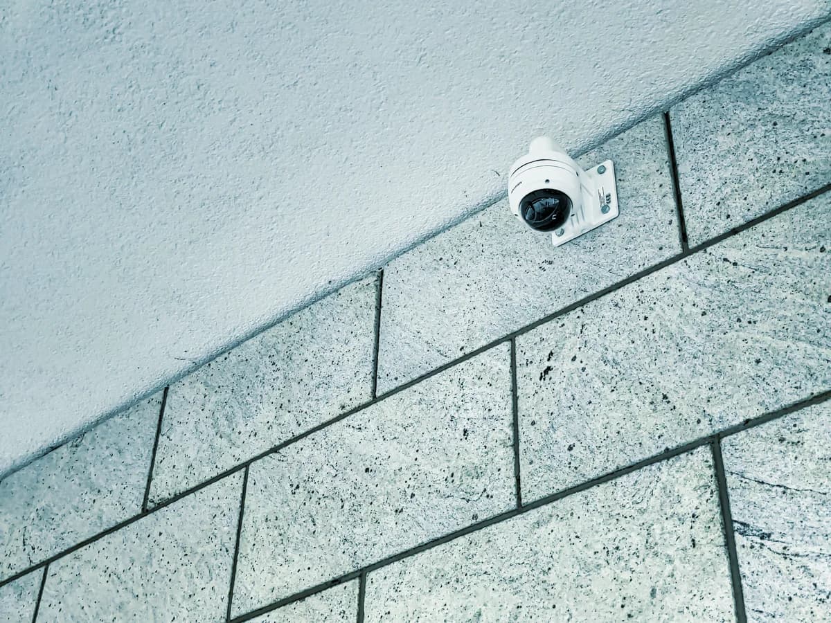 i-PRO bullet security camera mounted on a building exterior