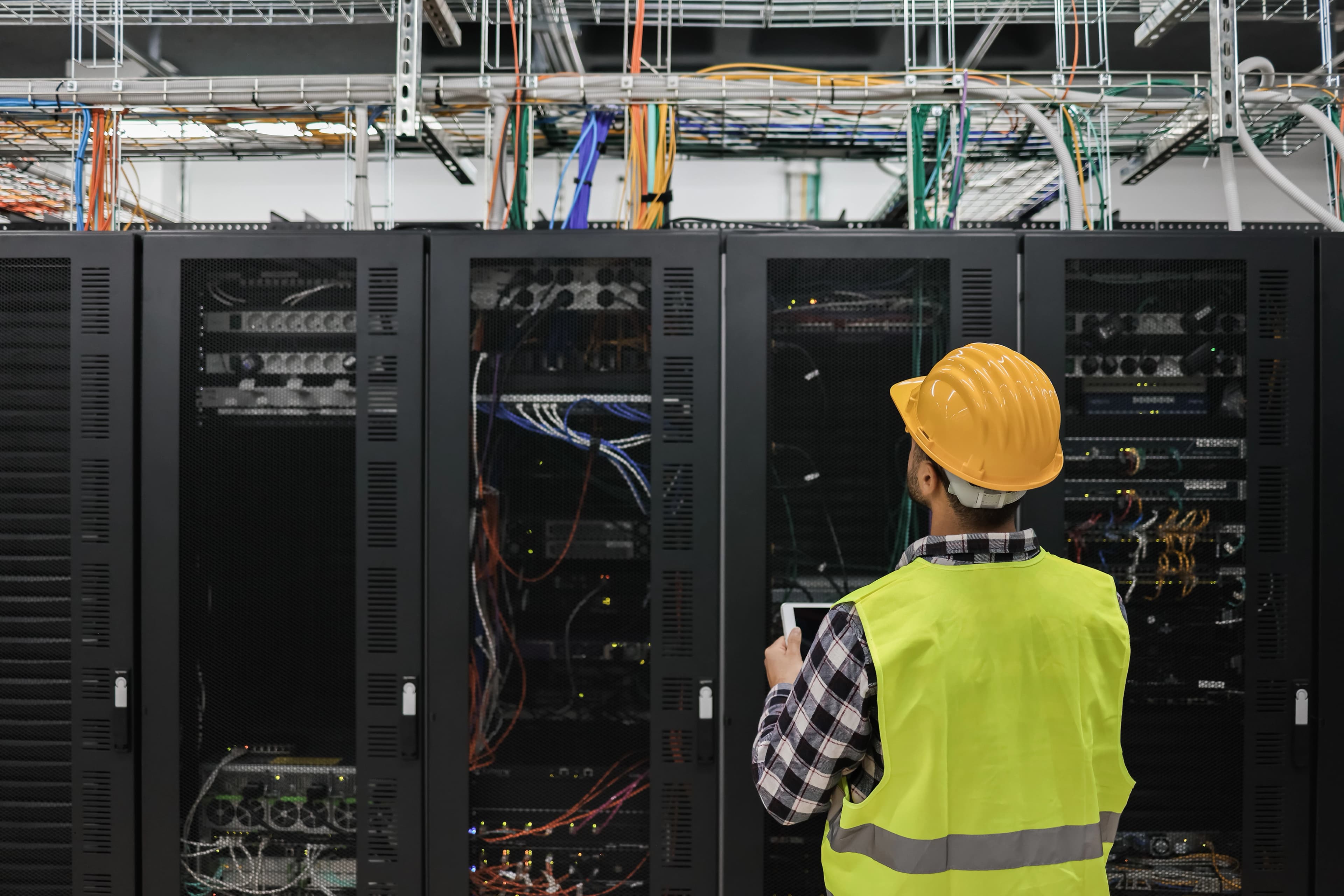 Technician configuring network equipment in a server rack