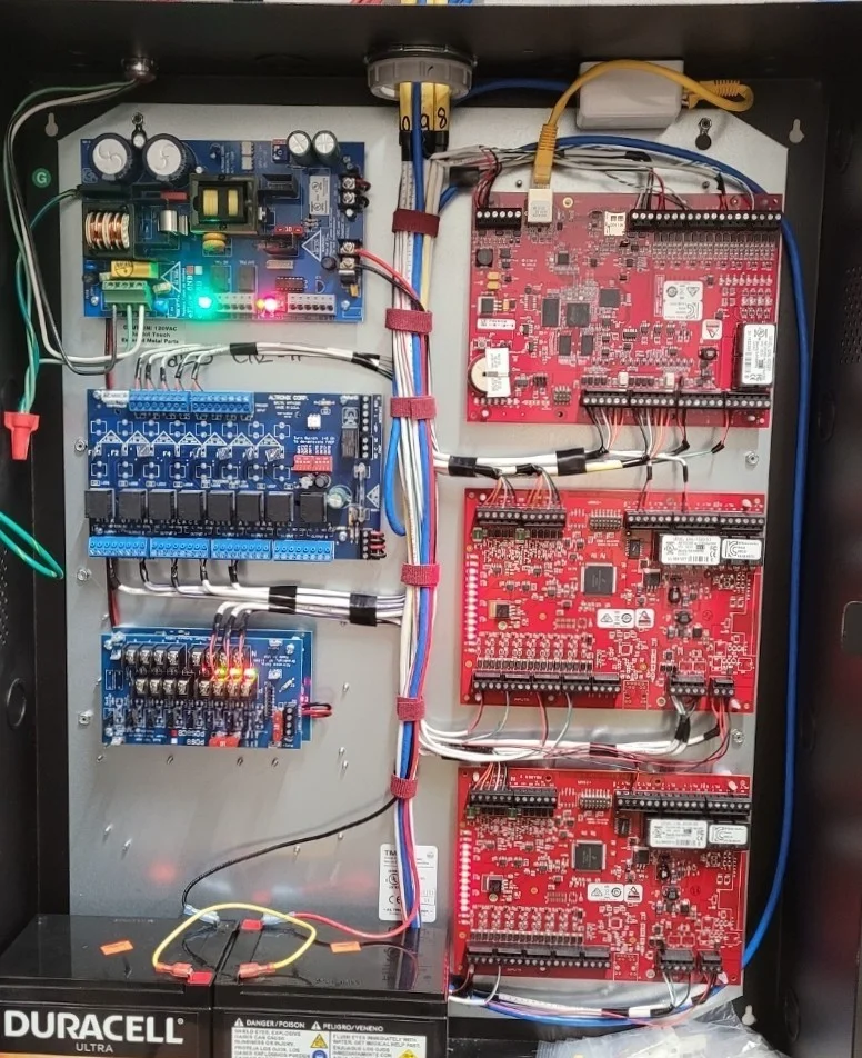 Six-door access control panel install with organized wiring and battery backup