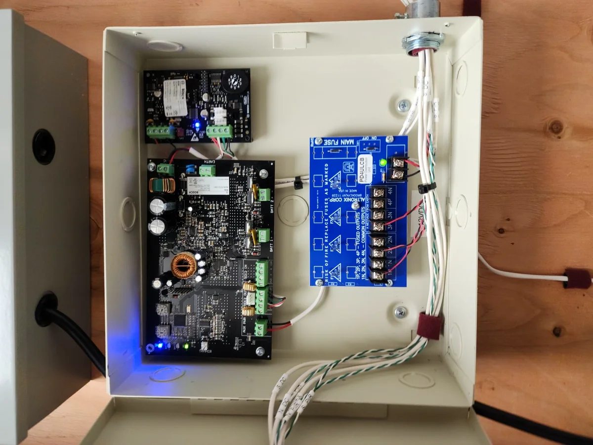 Bosch expansion modules and Altronix power supply in a labeled security enclosure